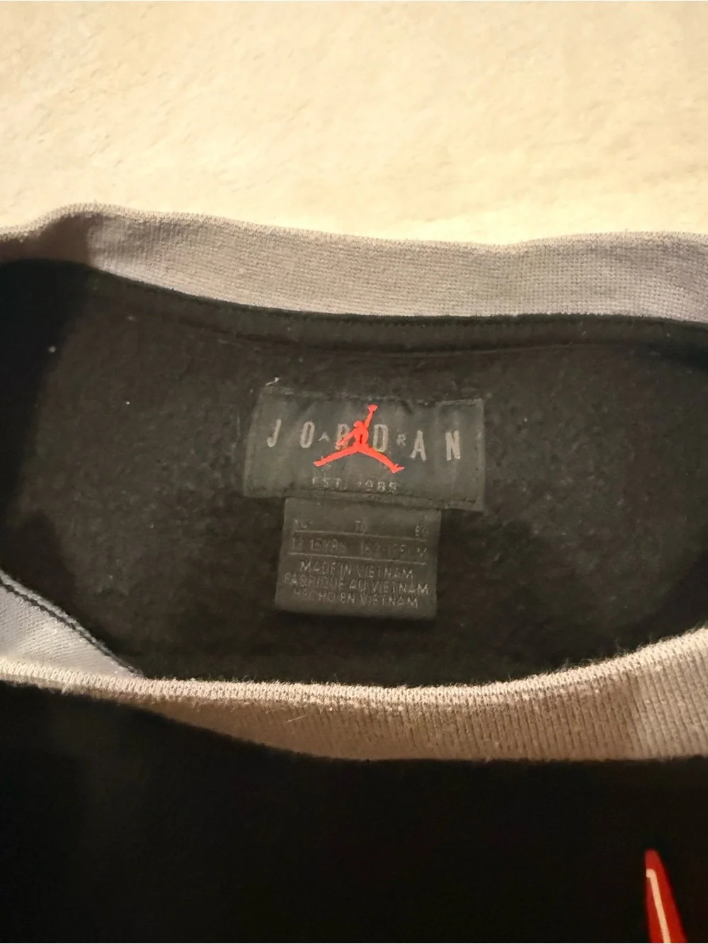 Nike Black Sweatshirt with Red Jordan Logo and Gray Neck Trim